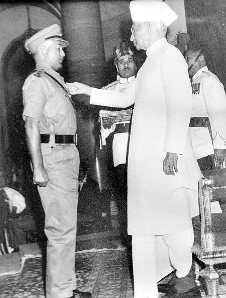 Receiving medal from President Radhakrishnan